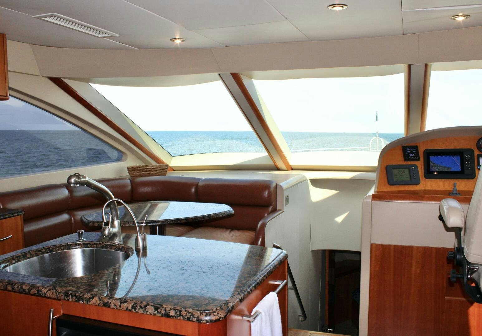 a kitchen with a sink and a tv on the wall aboard KATHLEEN Yacht for Sale