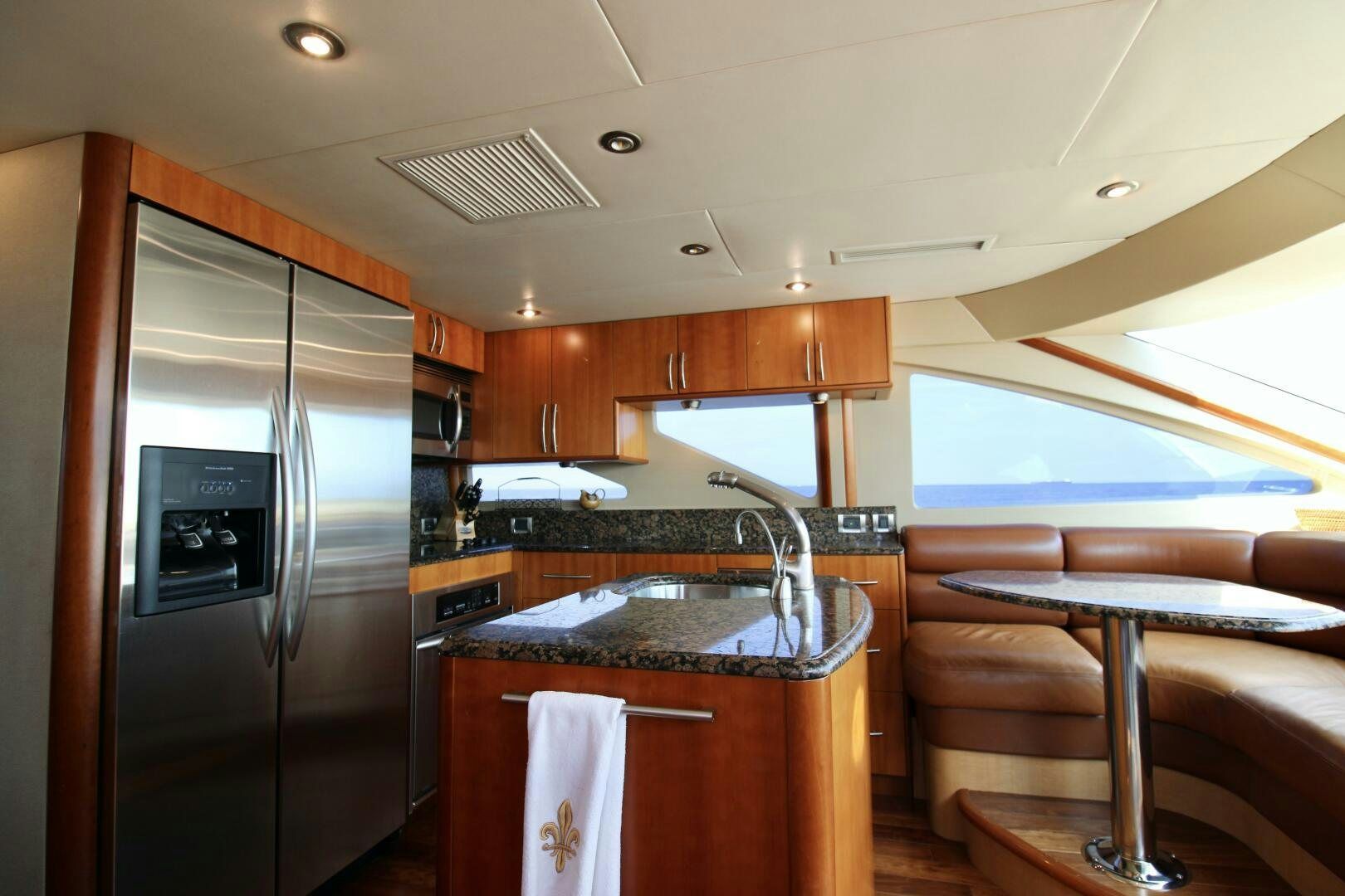 a kitchen with a stainless steel refrigerator aboard KATHLEEN Yacht for Sale