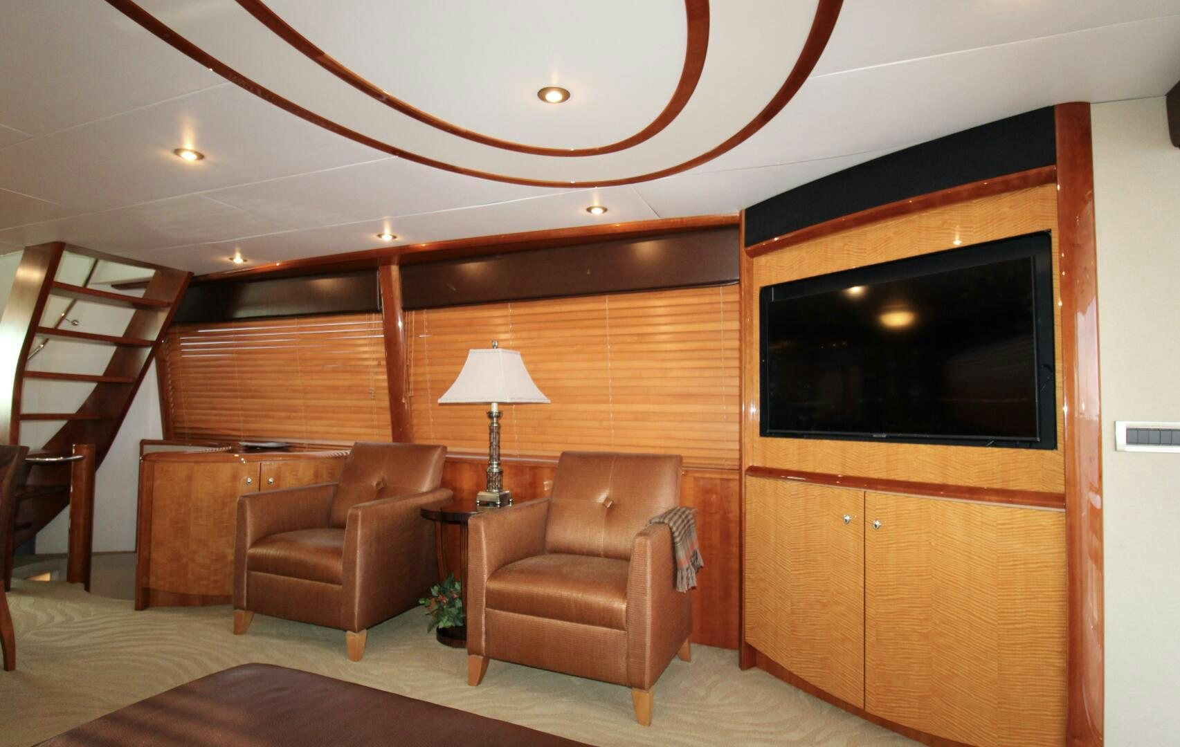 a living room with a leather chair and a television aboard KATHLEEN Yacht for Sale