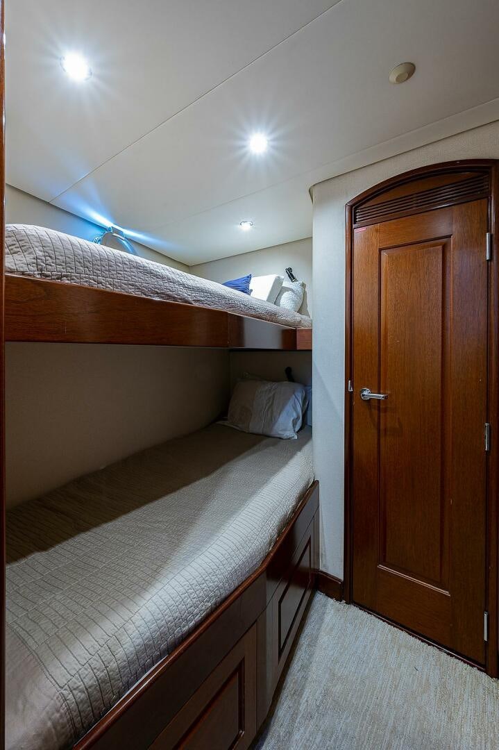 a bedroom with a bed and a closet aboard LA SIRENA Yacht for Sale