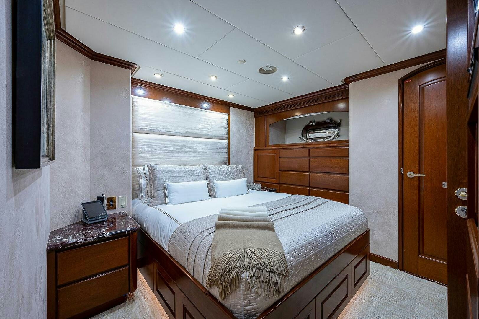 a bedroom with a bed and a desk aboard LA SIRENA Yacht for Sale