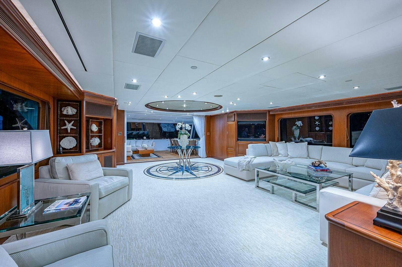 a living room with a large white sofa and a large fireplace aboard LA SIRENA Yacht for Sale
