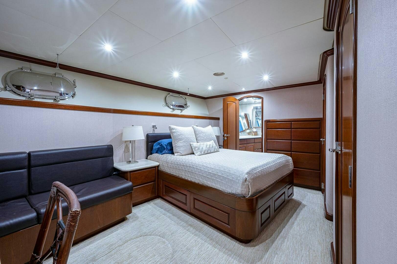 a bedroom with a bed and a couch aboard LA SIRENA Yacht for Sale