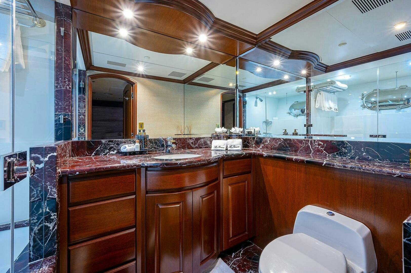 a bathroom with a large glass shower aboard LA SIRENA Yacht for Sale