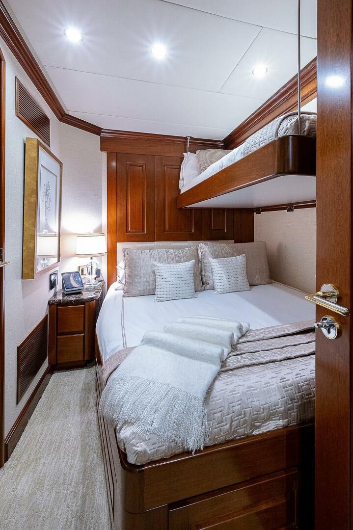 a bed with a white bed spread aboard LA SIRENA Yacht for Sale