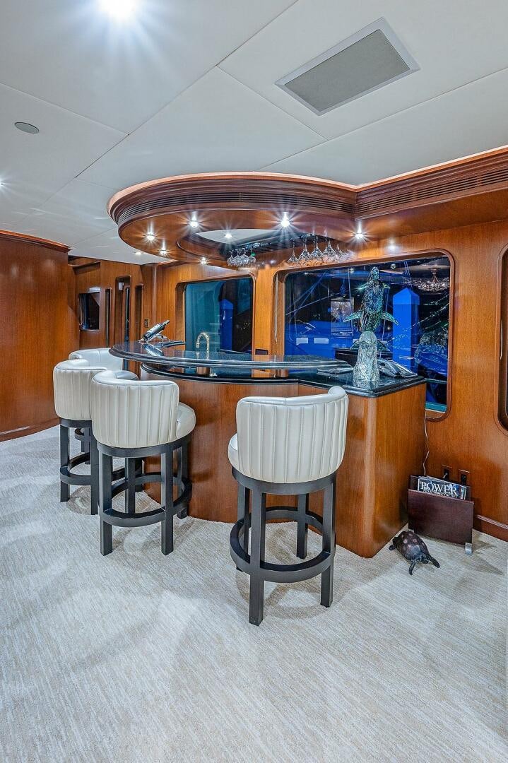 a room with a table and chairs aboard LA SIRENA Yacht for Sale