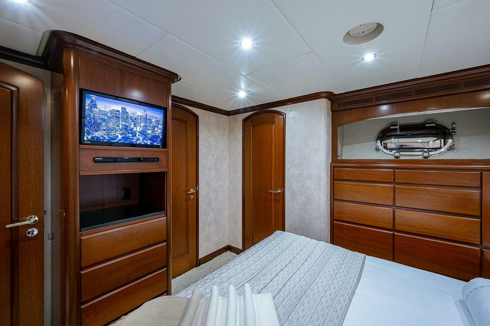 a bedroom with a tv and a bed aboard LA SIRENA Yacht for Sale