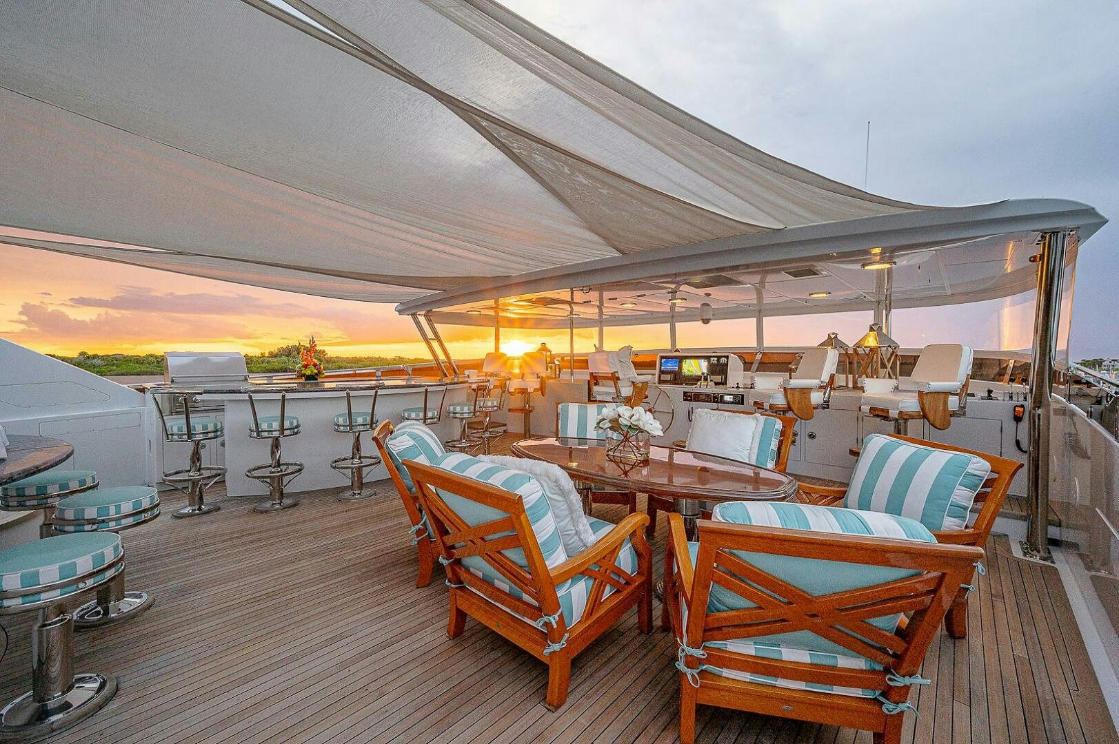 a room with tables and chairs aboard LA SIRENA Yacht for Sale