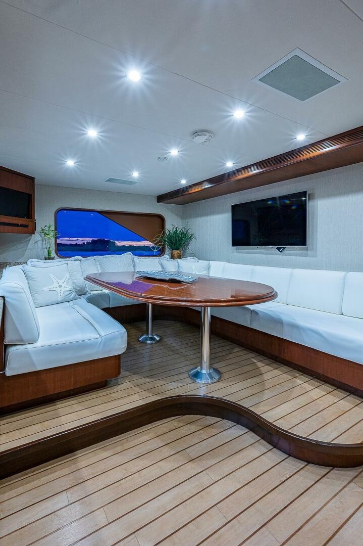 a living room with a table and couches aboard LA SIRENA Yacht for Sale