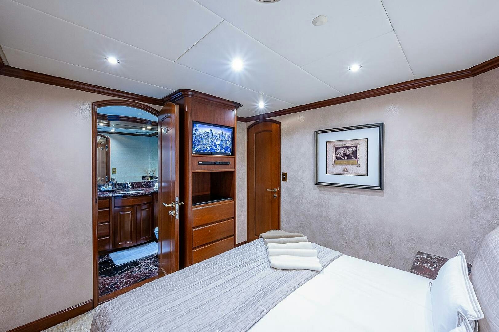 a hotel room with a bed and a tv aboard LA SIRENA Yacht for Sale