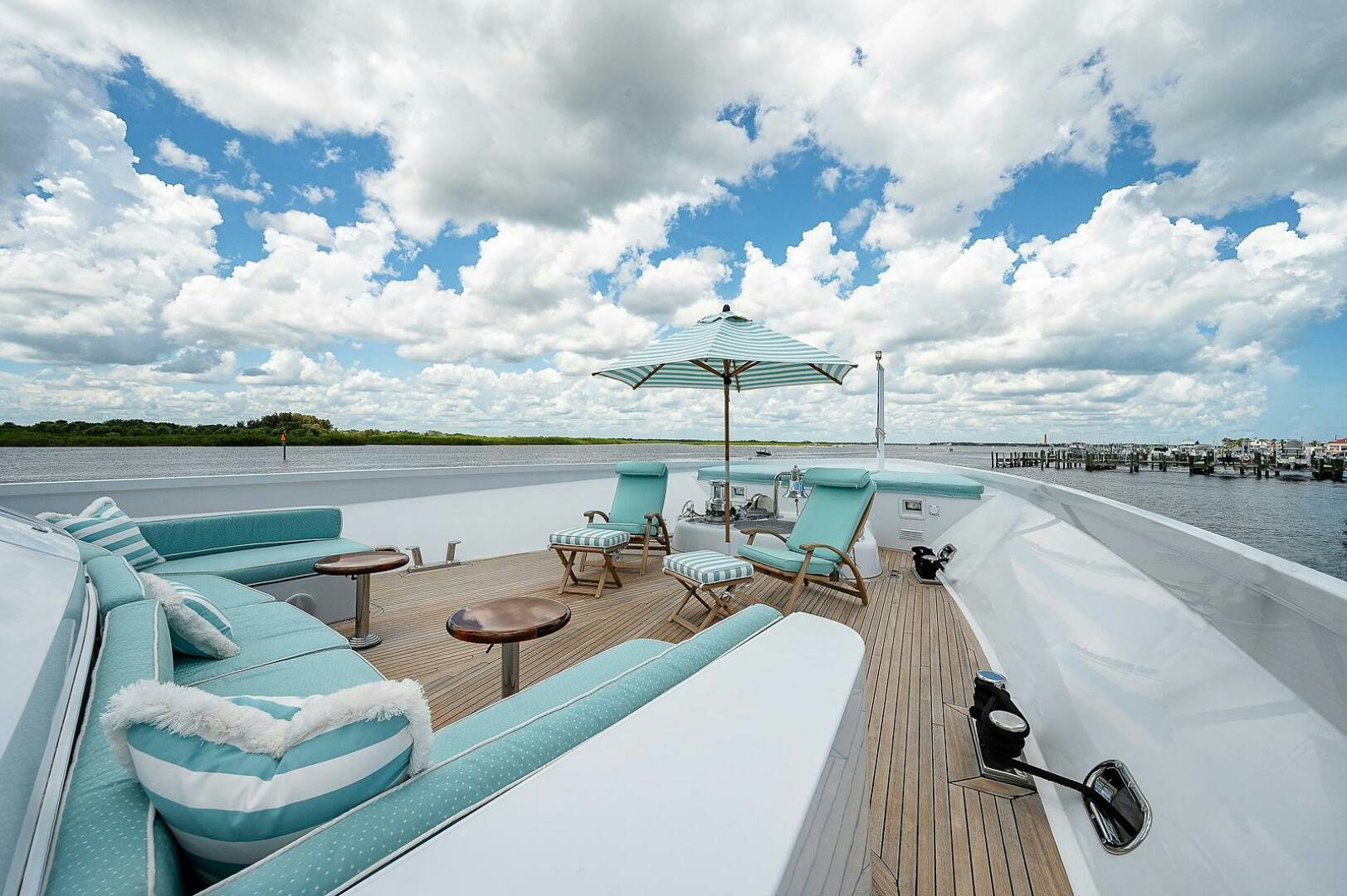 a deck with chairs and an umbrella aboard LA SIRENA Yacht for Sale