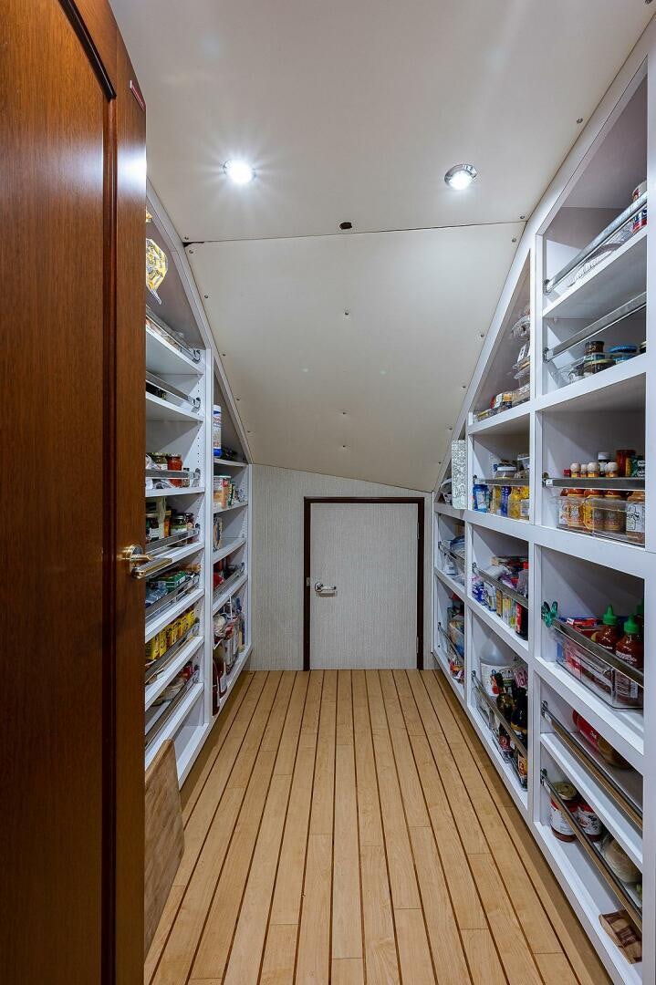 a room with shelves and shelves aboard LA SIRENA Yacht for Sale