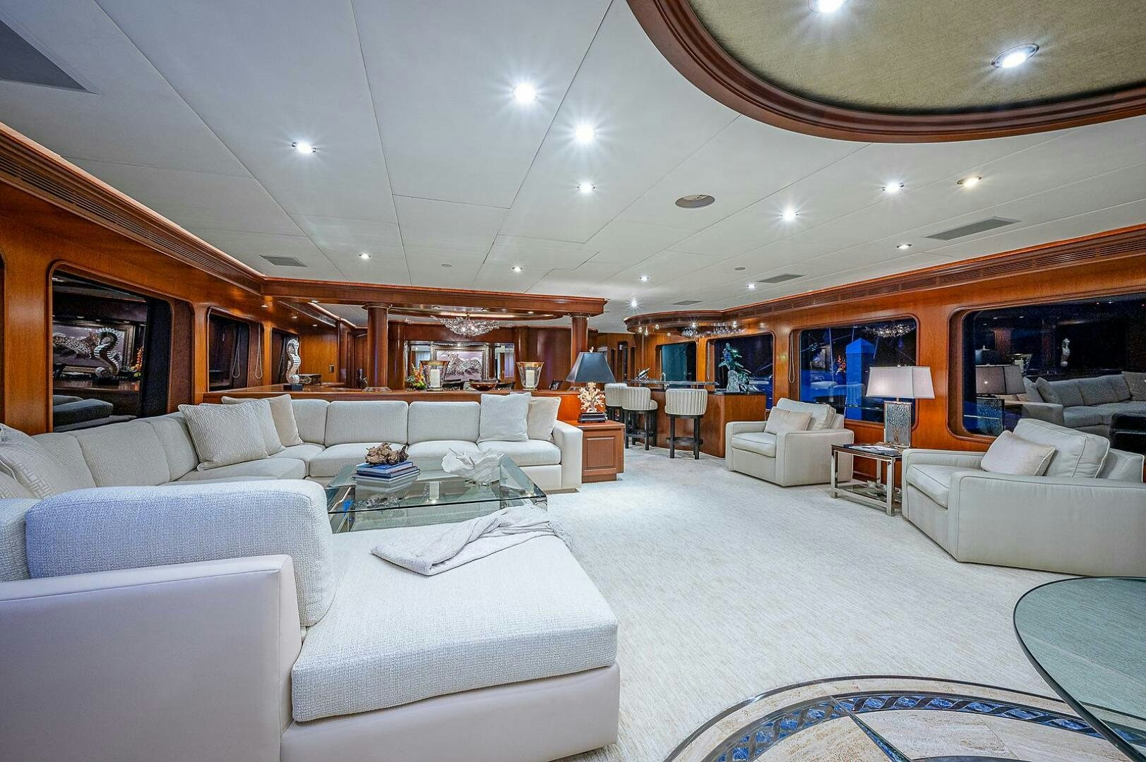a large living room with white couches and a large window aboard LA SIRENA Yacht for Sale