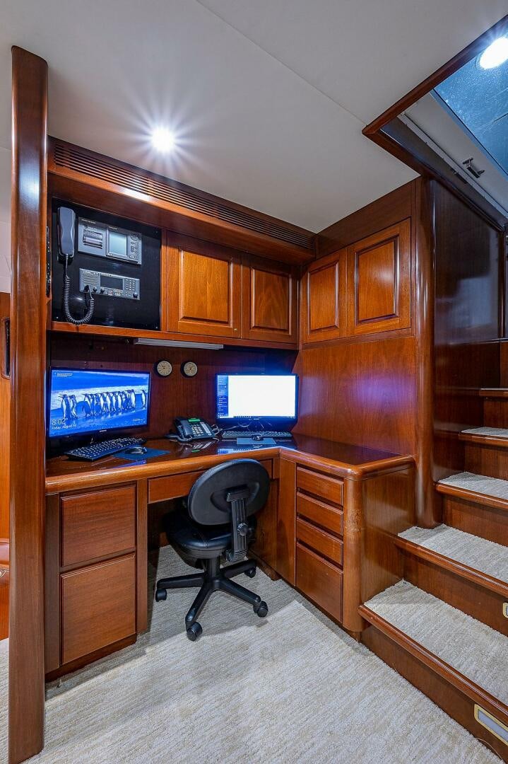 a computer desk with two monitors aboard LA SIRENA Yacht for Sale