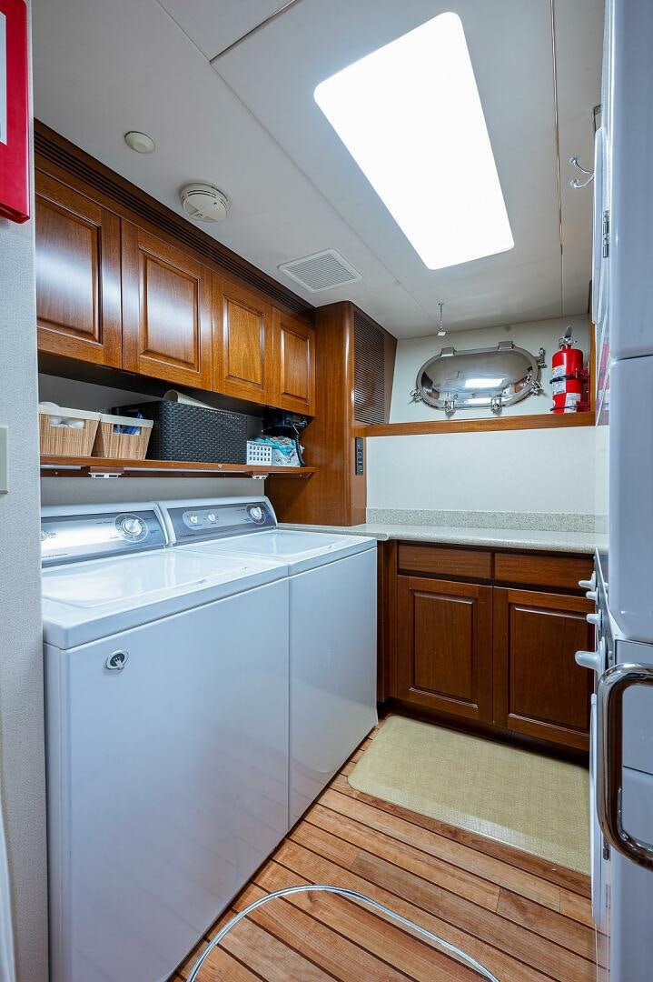 a kitchen with wooden cabinets aboard LA SIRENA Yacht for Sale