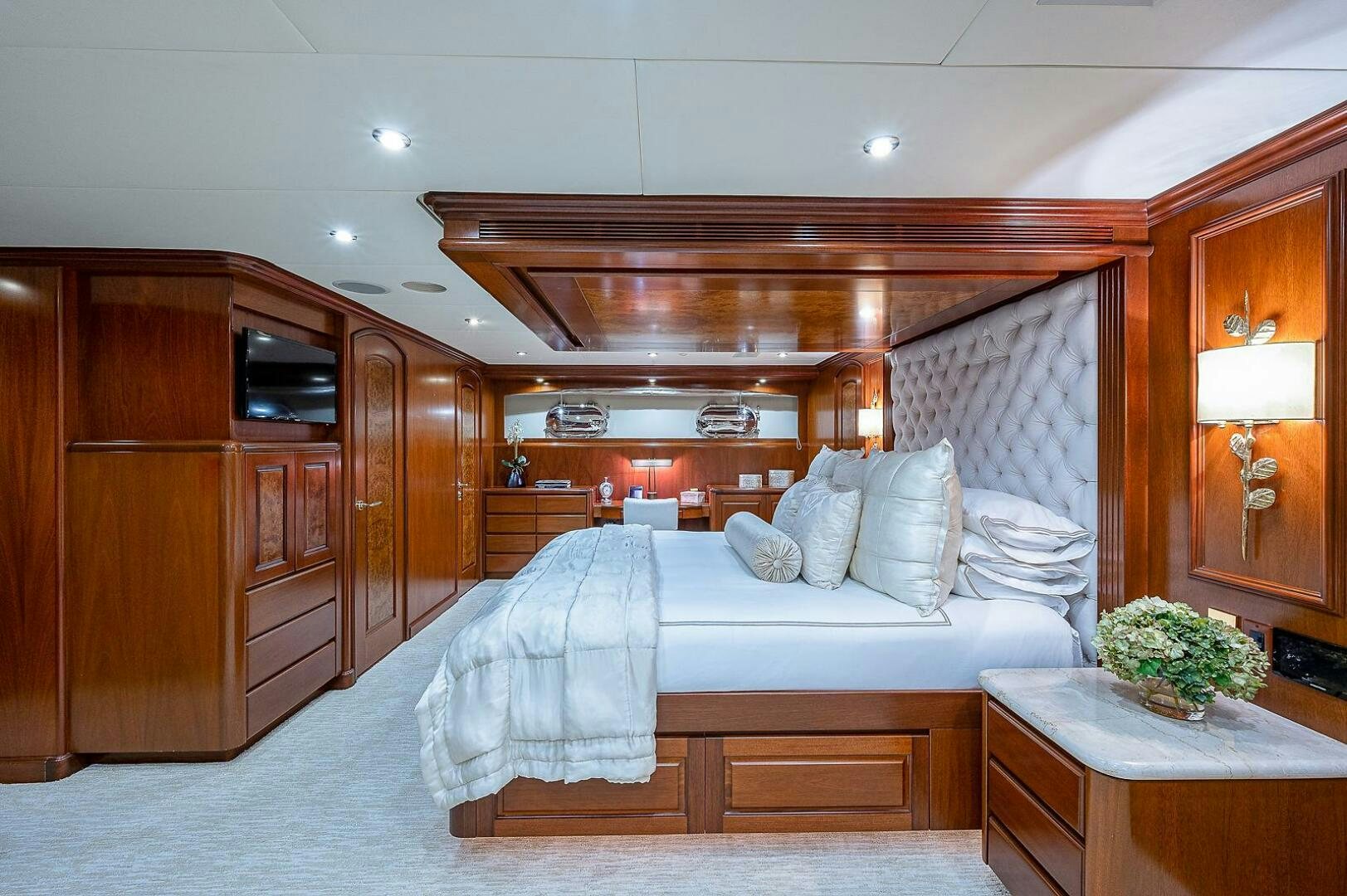 a bedroom with a bed and a desk aboard LA SIRENA Yacht for Sale