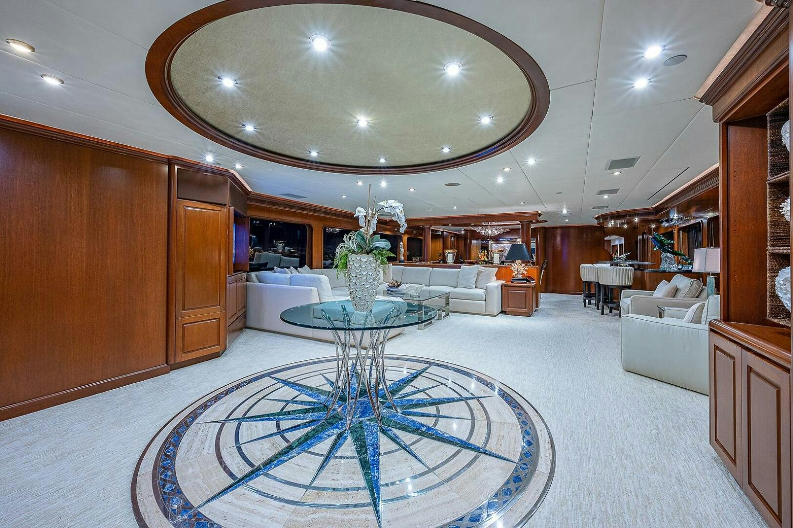 a large room with a table and chairs aboard LA SIRENA Yacht for Sale