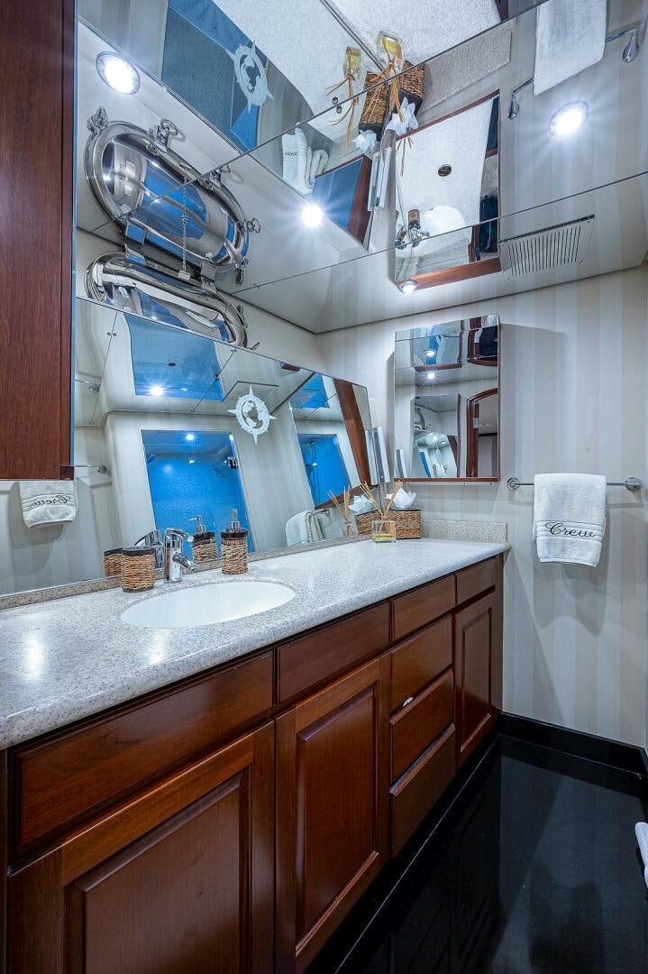 a bathroom with a sink and a mirror aboard LA SIRENA Yacht for Sale