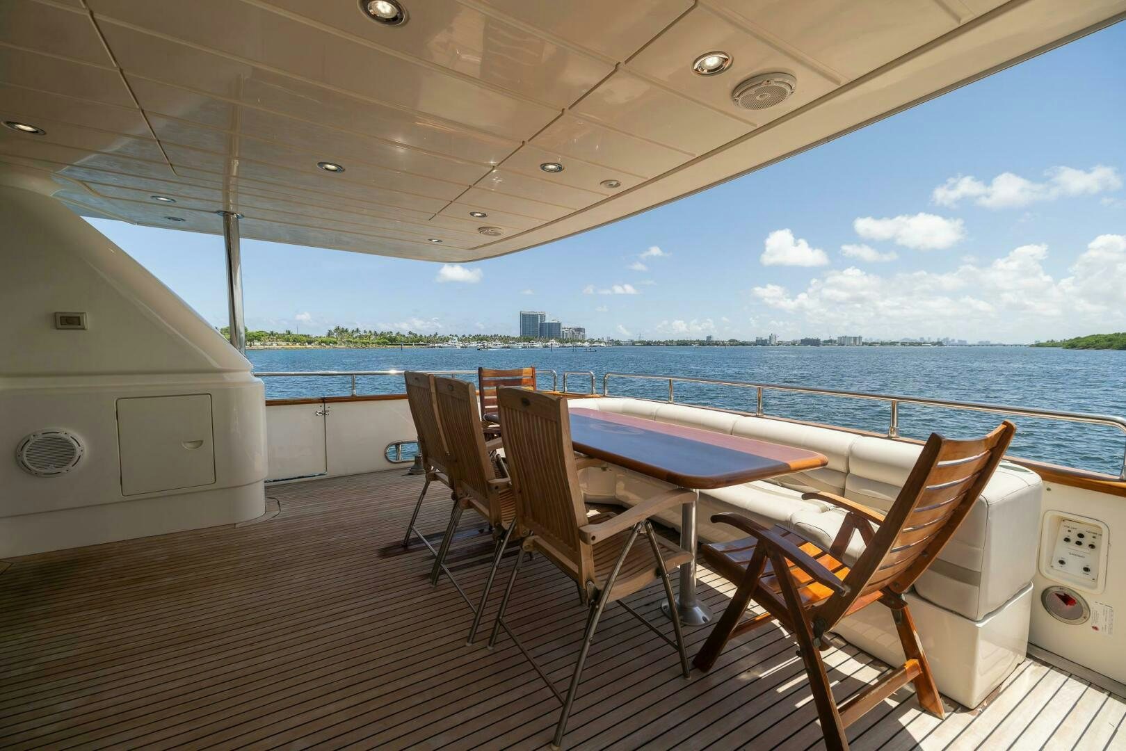 a deck with chairs and a table on it aboard ONE MORE TIME Yacht for Sale