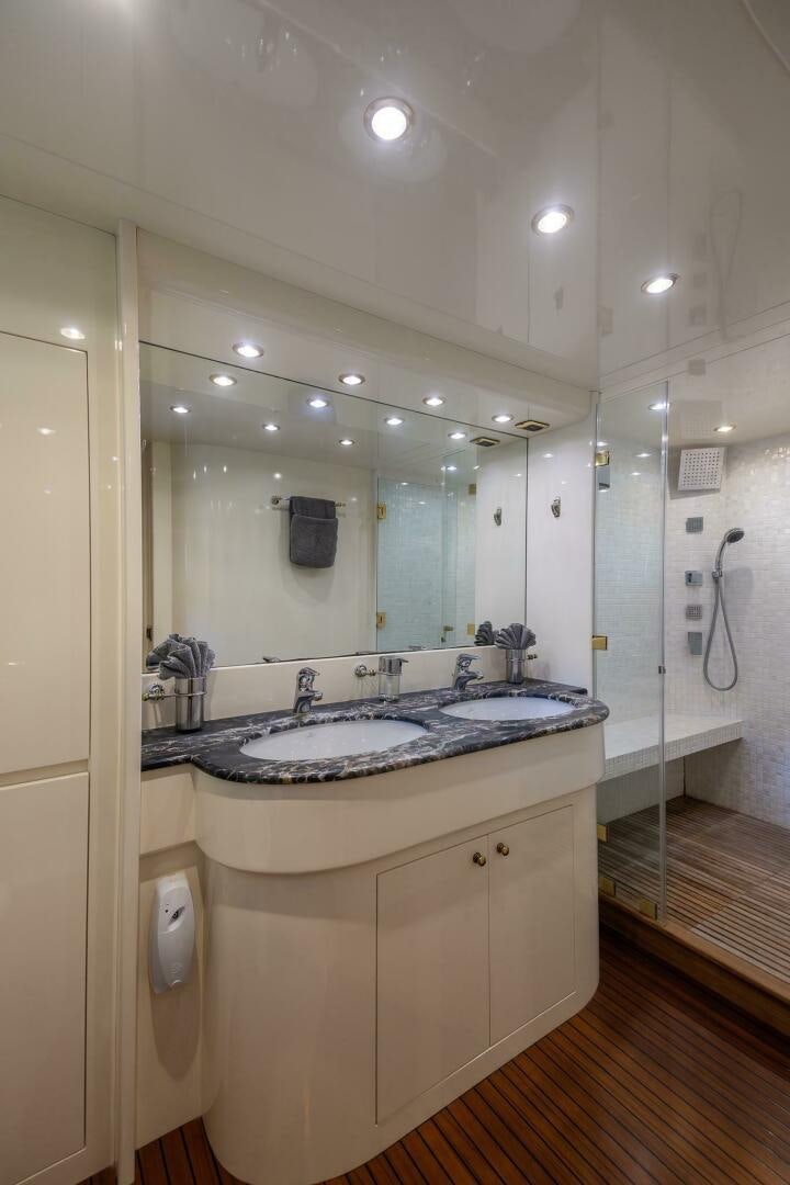 a bathroom with a large mirror aboard ONE MORE TIME Yacht for Sale