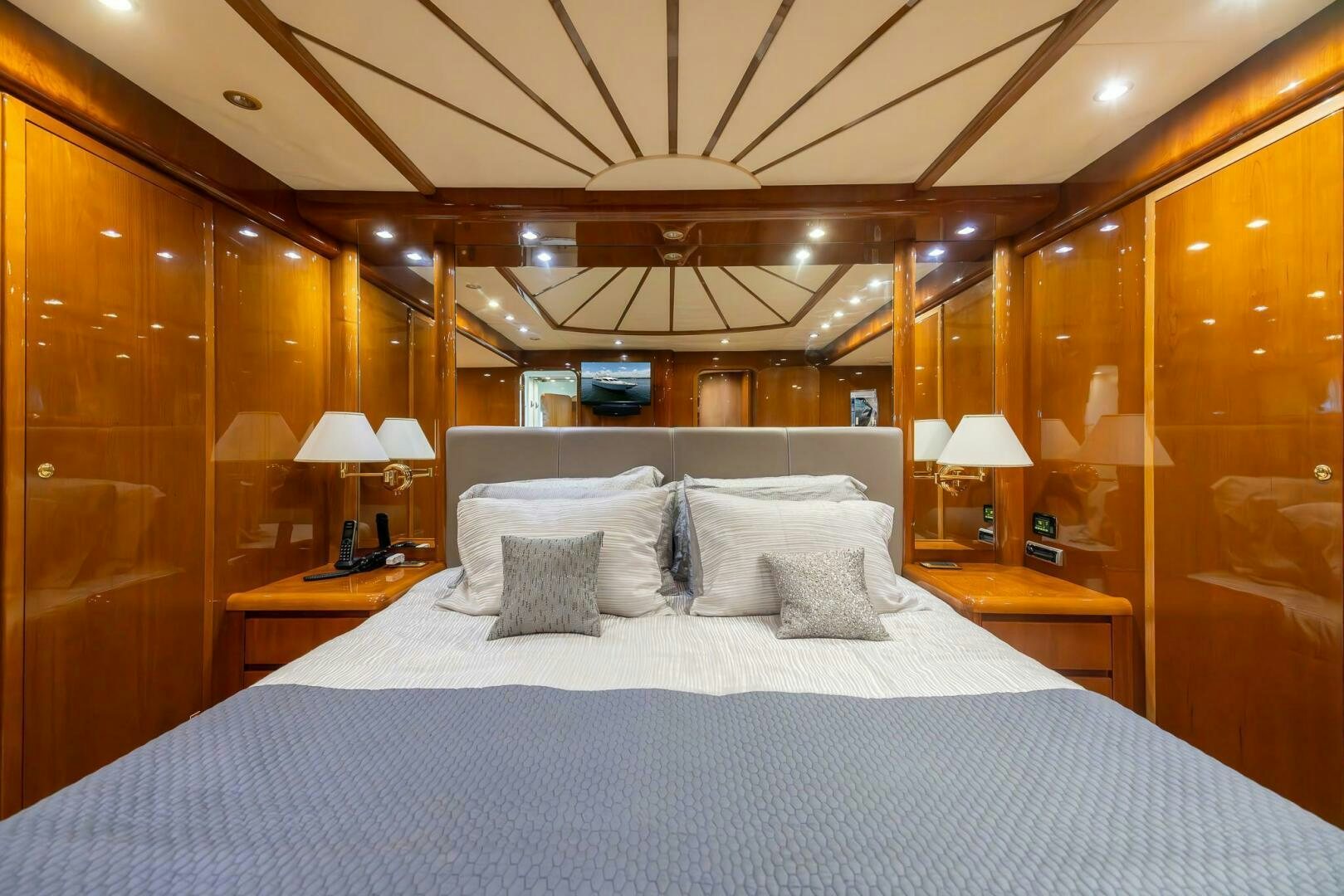 a bed with a blue and white bed spread aboard ONE MORE TIME Yacht for Sale
