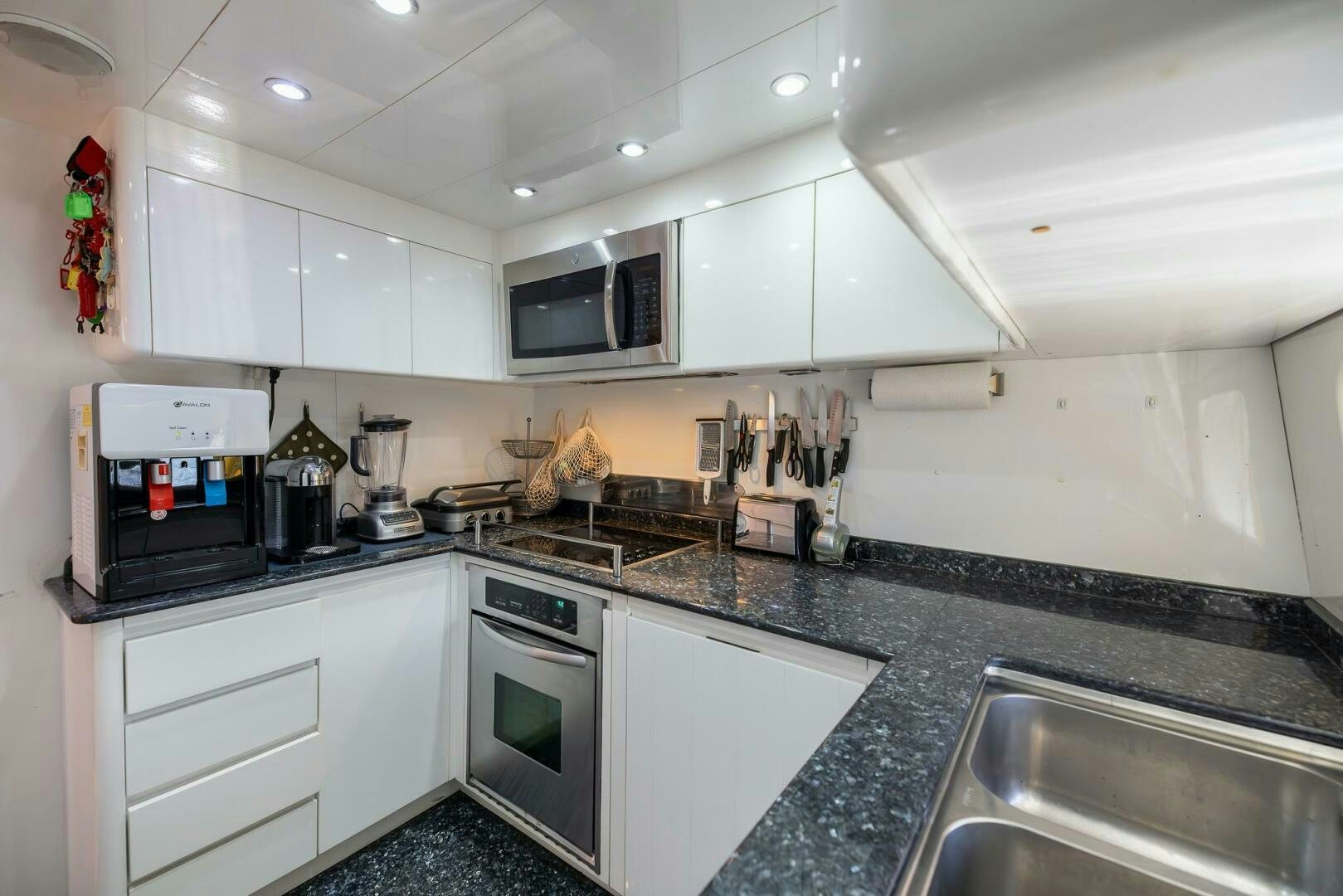 a kitchen with white cabinets aboard ONE MORE TIME Yacht for Sale