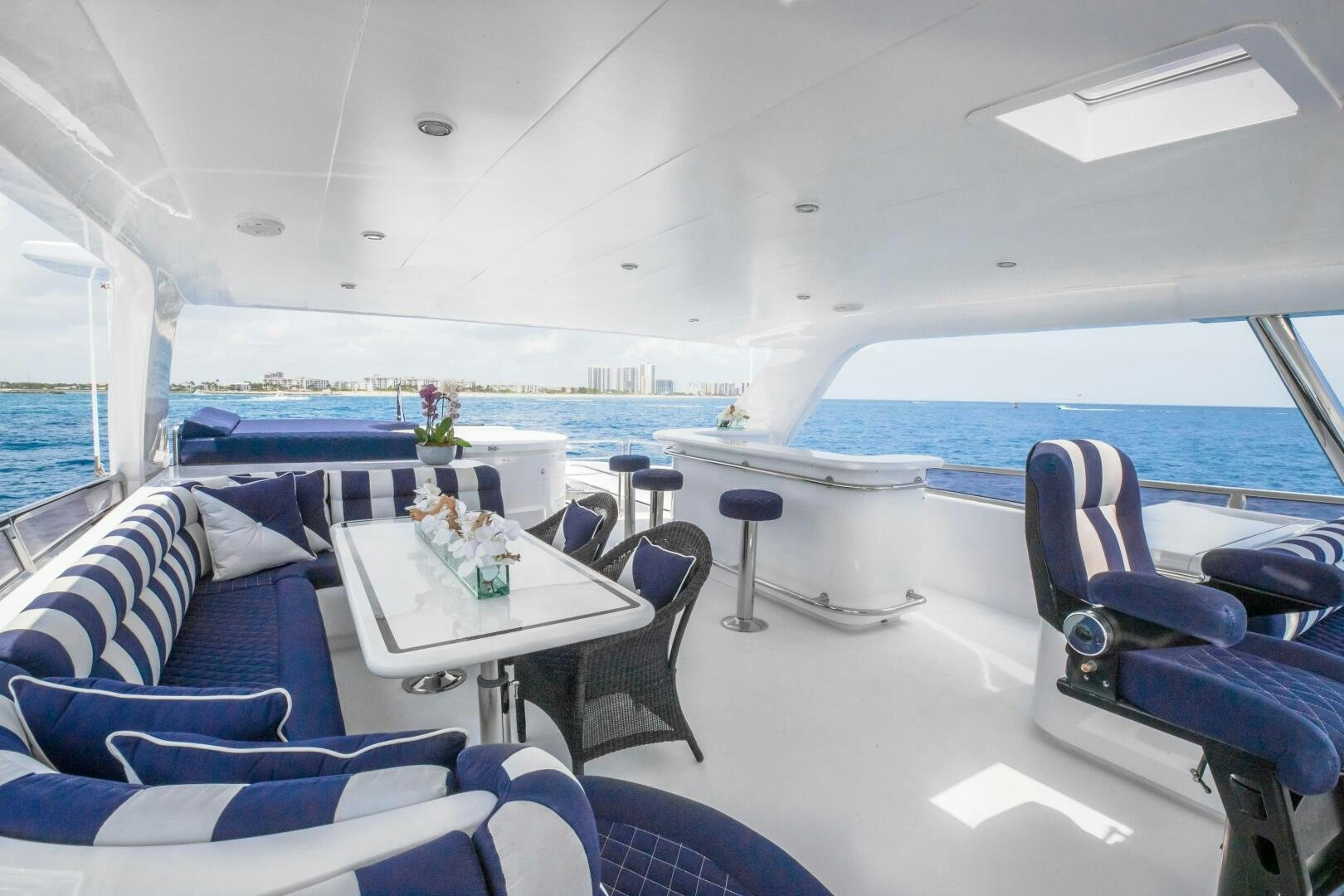 a room with a table chairs and a large pool aboard KENTUCKY BELLE Yacht for Sale