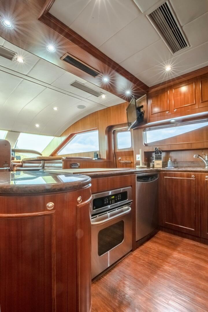 a kitchen with wooden cabinets aboard KENTUCKY BELLE Yacht for Sale