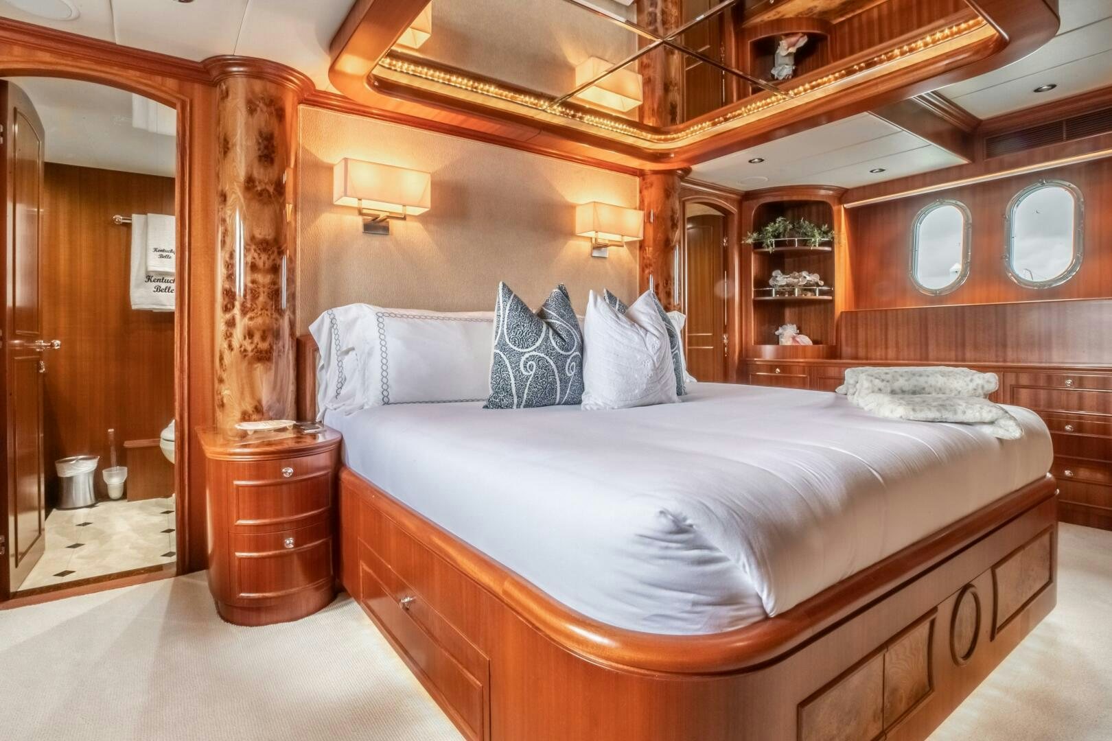 a bed with a white sheet and pillows aboard KENTUCKY BELLE Yacht for Sale