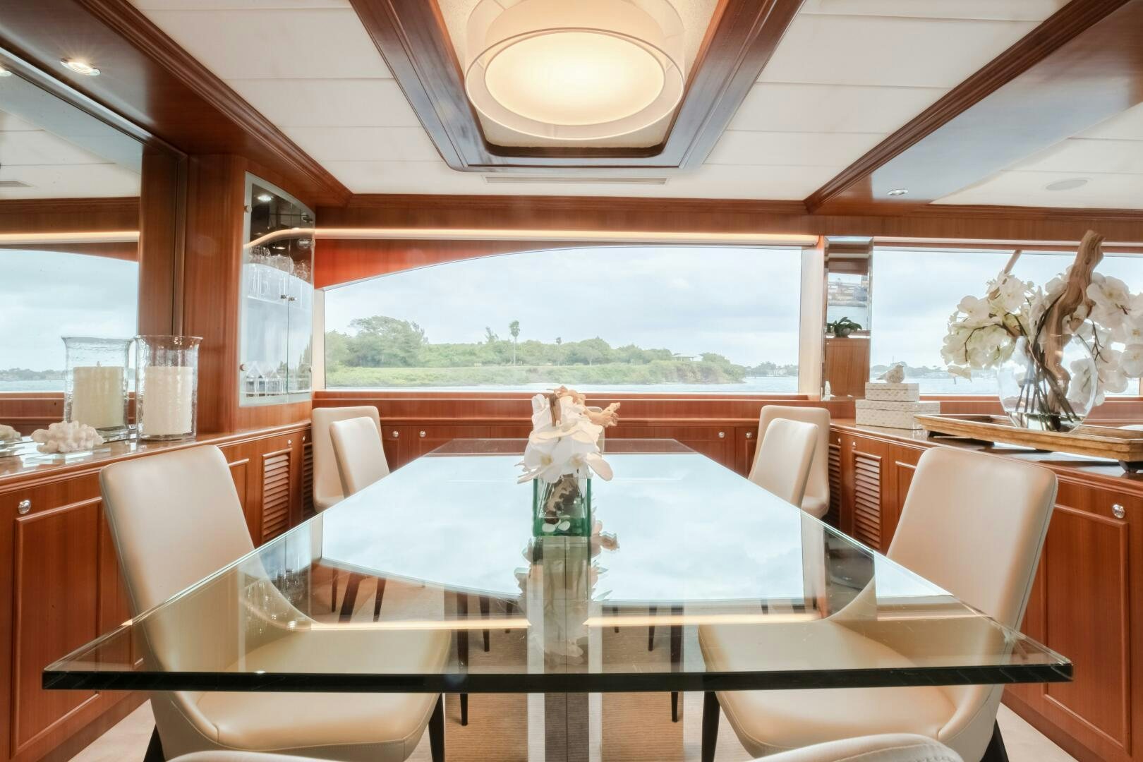 a dining table with white flowers aboard KENTUCKY BELLE Yacht for Sale