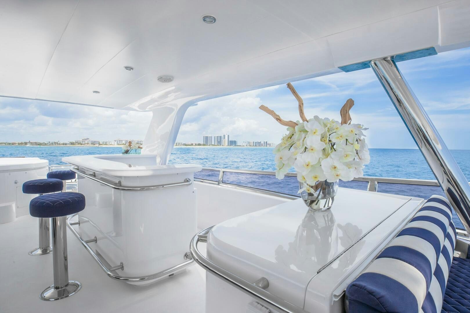 a white table with a vase of flowers on it aboard KENTUCKY BELLE Yacht for Sale