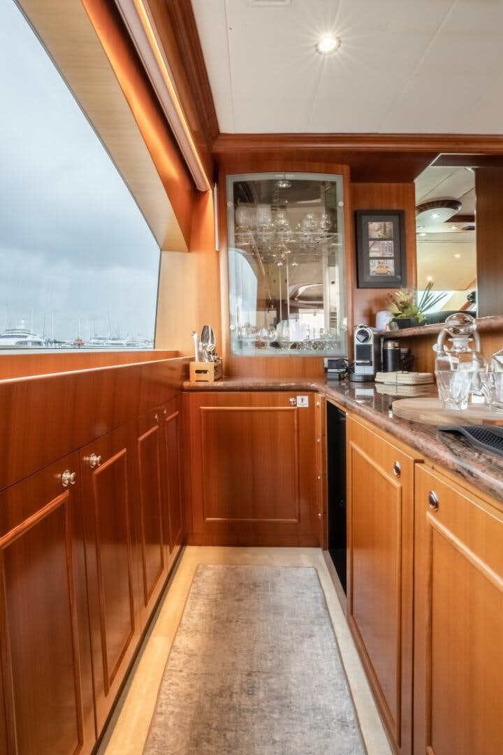 a kitchen with wooden cabinets aboard KENTUCKY BELLE Yacht for Sale