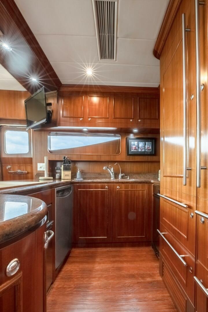 a kitchen with wooden cabinets aboard KENTUCKY BELLE Yacht for Sale