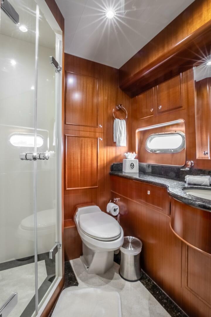 a bathroom with a glass shower aboard KENTUCKY BELLE Yacht for Sale