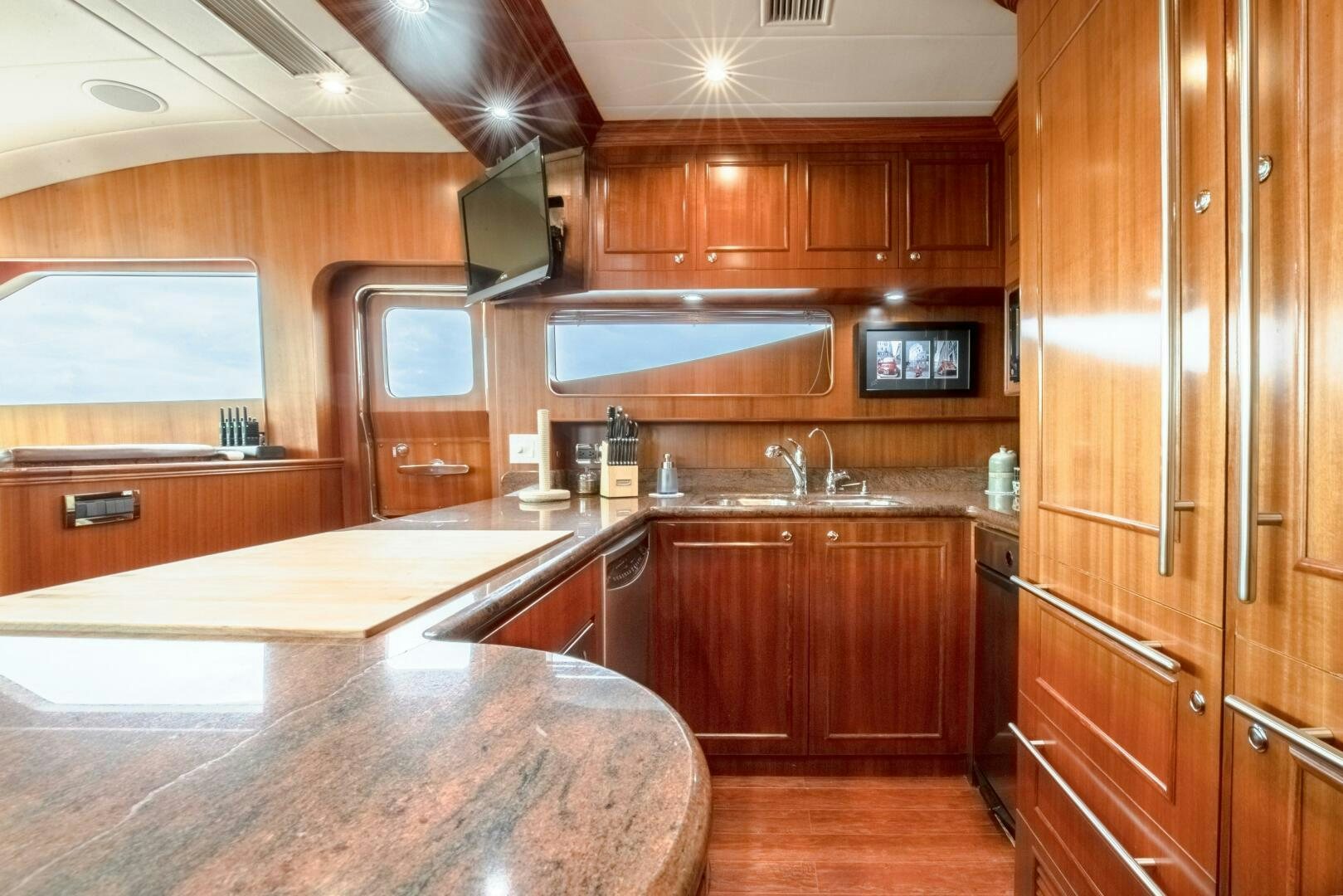 a kitchen with wooden cabinets aboard KENTUCKY BELLE Yacht for Sale