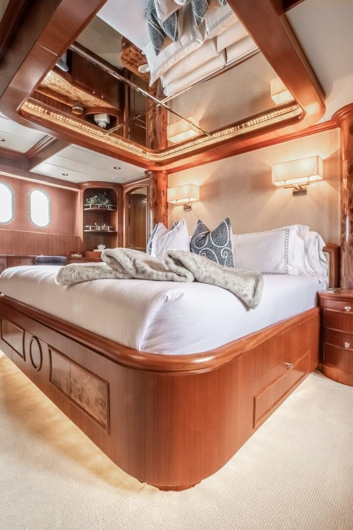 a bed with a wooden frame aboard KENTUCKY BELLE Yacht for Sale