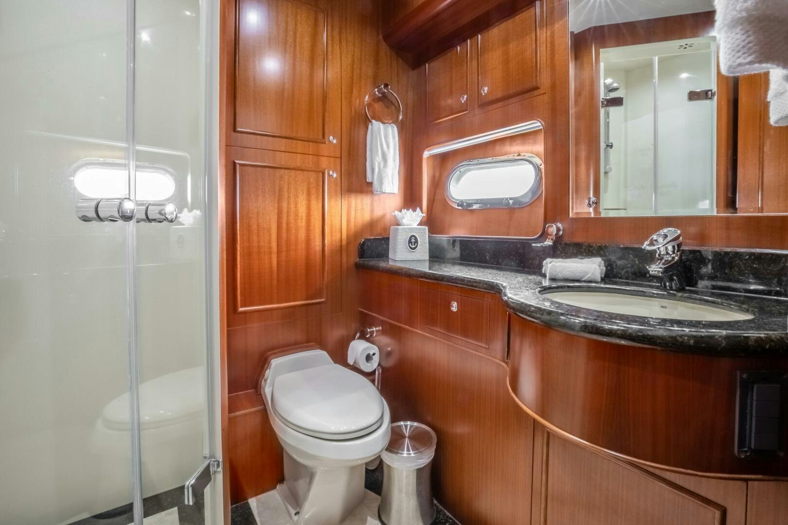 a bathroom with a glass shower door aboard KENTUCKY BELLE Yacht for Sale
