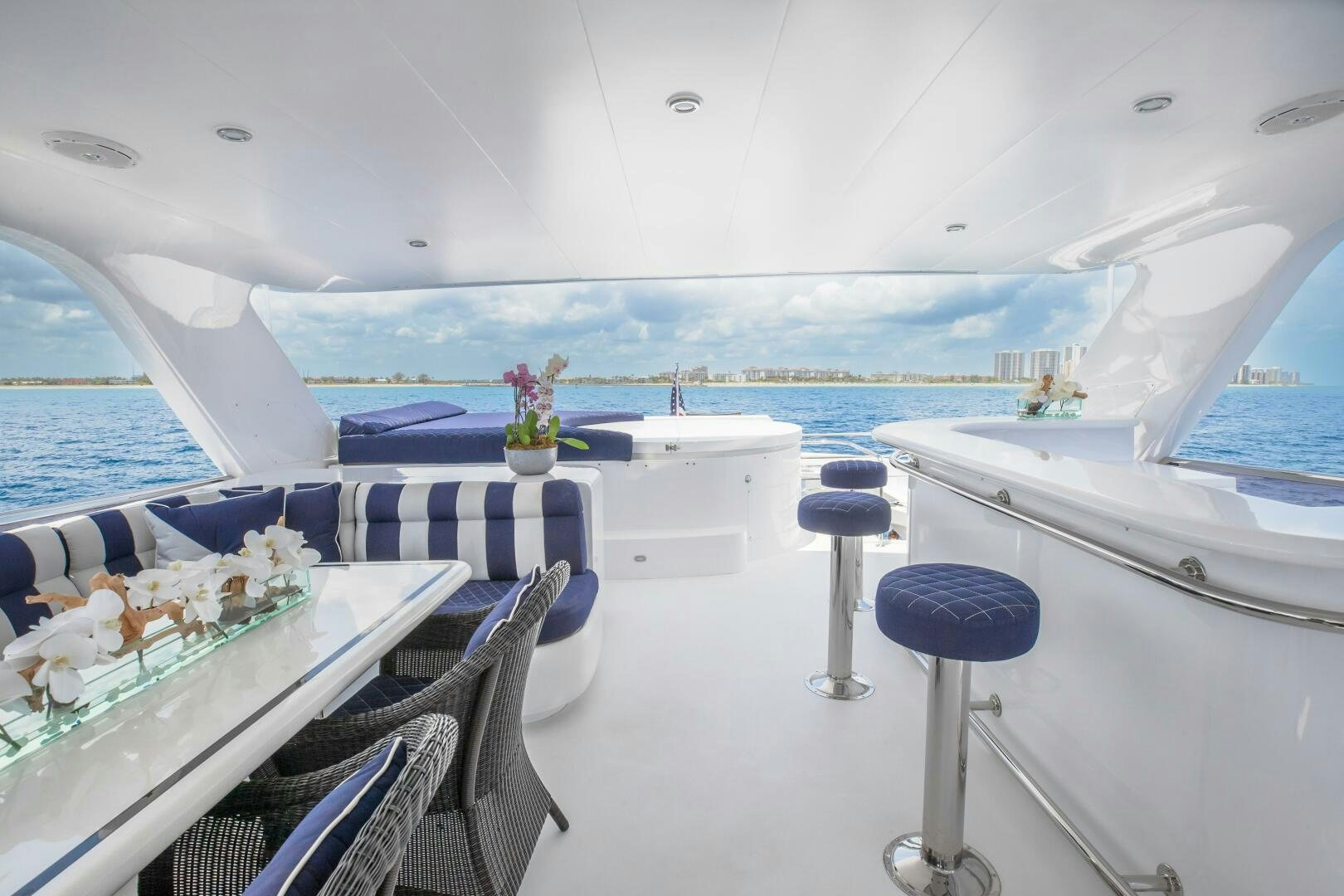 a room with a table chairs and a view of the ocean aboard KENTUCKY BELLE Yacht for Sale