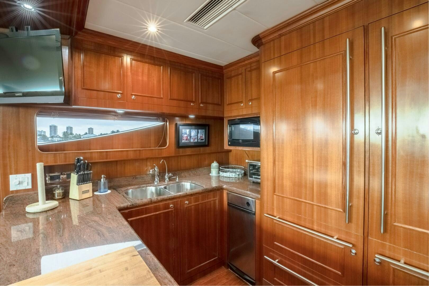 a kitchen with wooden cabinets aboard KENTUCKY BELLE Yacht for Sale