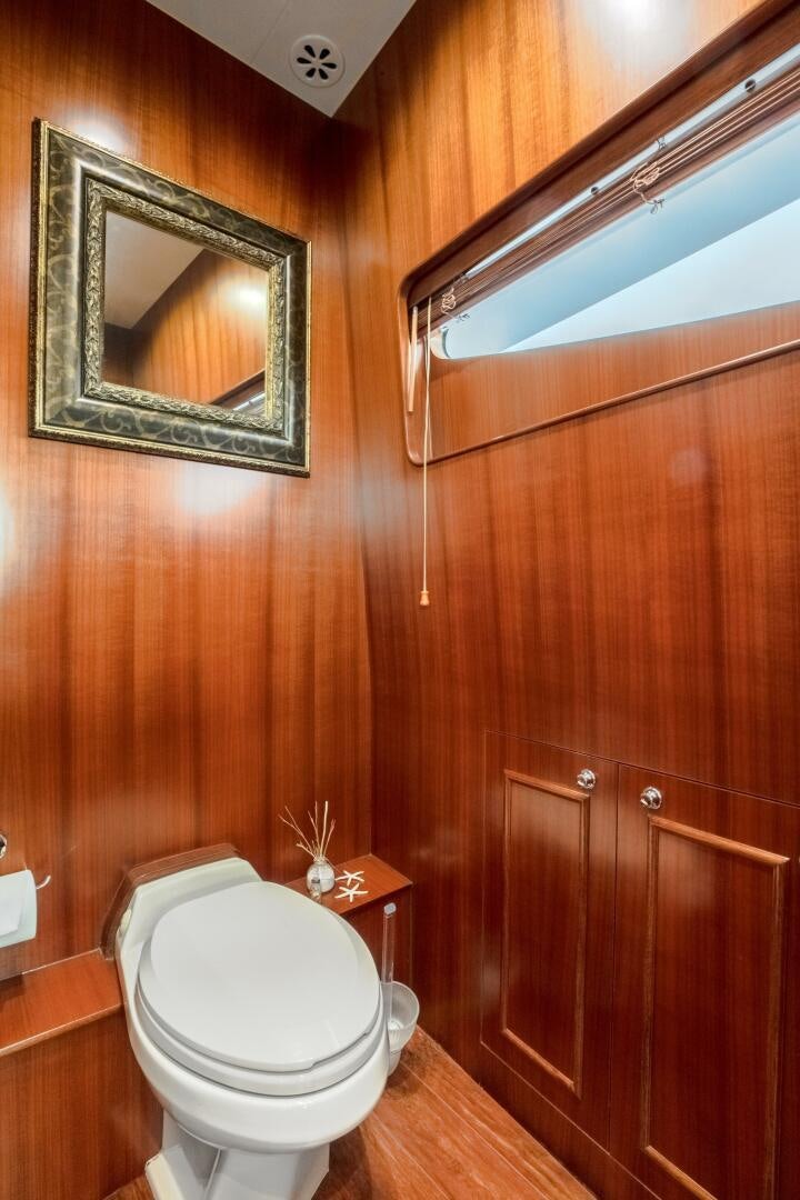 a bathroom with wooden walls aboard KENTUCKY BELLE Yacht for Sale