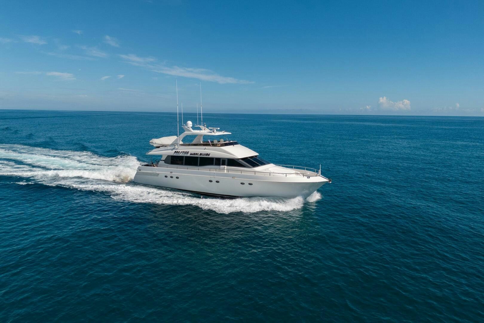 a white boat on the water aboard PRESTIGE WORLDWIDE Yacht for Sale