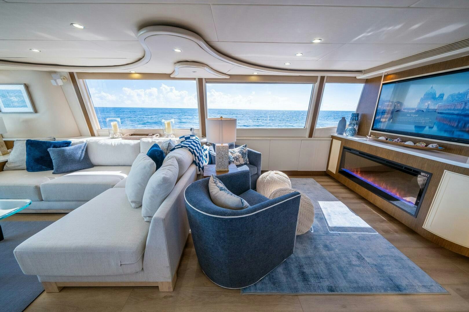 a living room with a large television aboard PRESTIGE WORLDWIDE Yacht for Sale