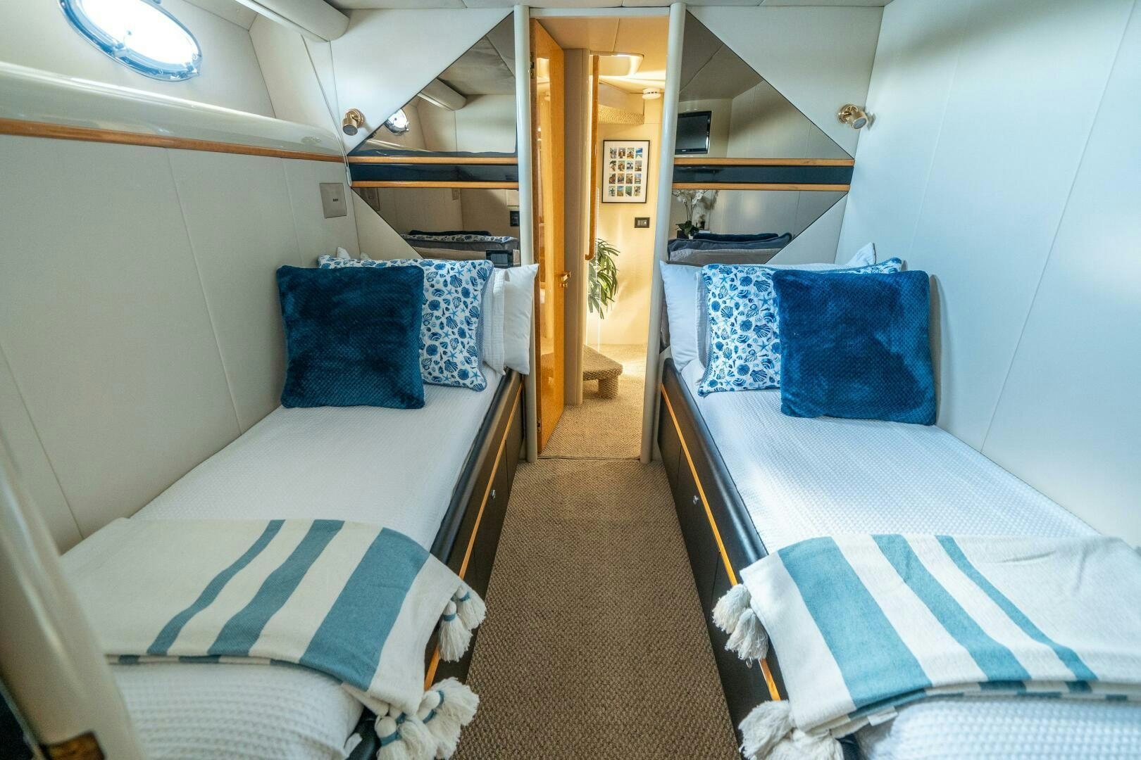 a couple of beds in a room aboard PRESTIGE WORLDWIDE Yacht for Sale