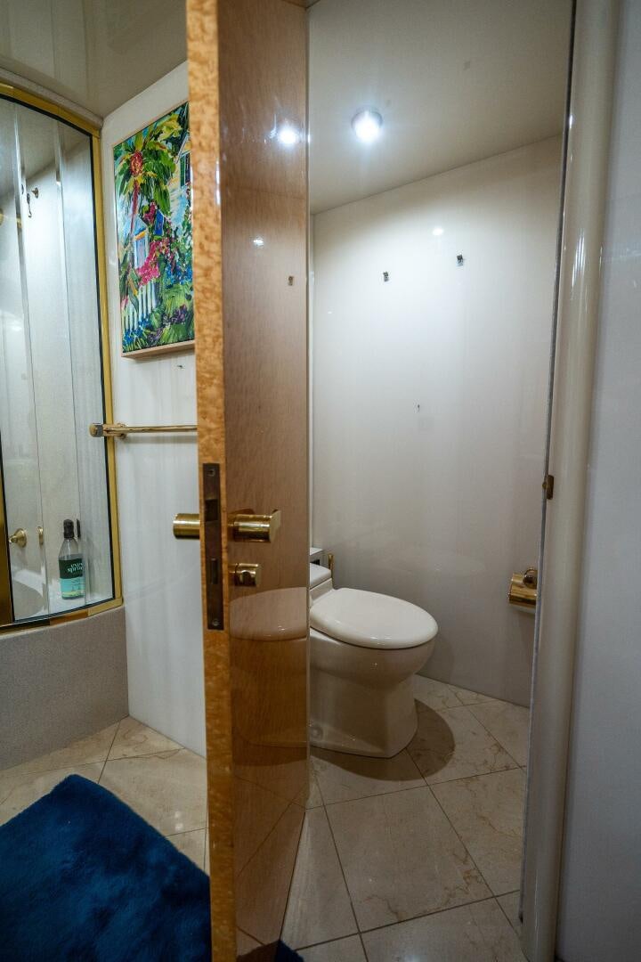 a bathroom with a painting on the wall aboard PRESTIGE WORLDWIDE Yacht for Sale