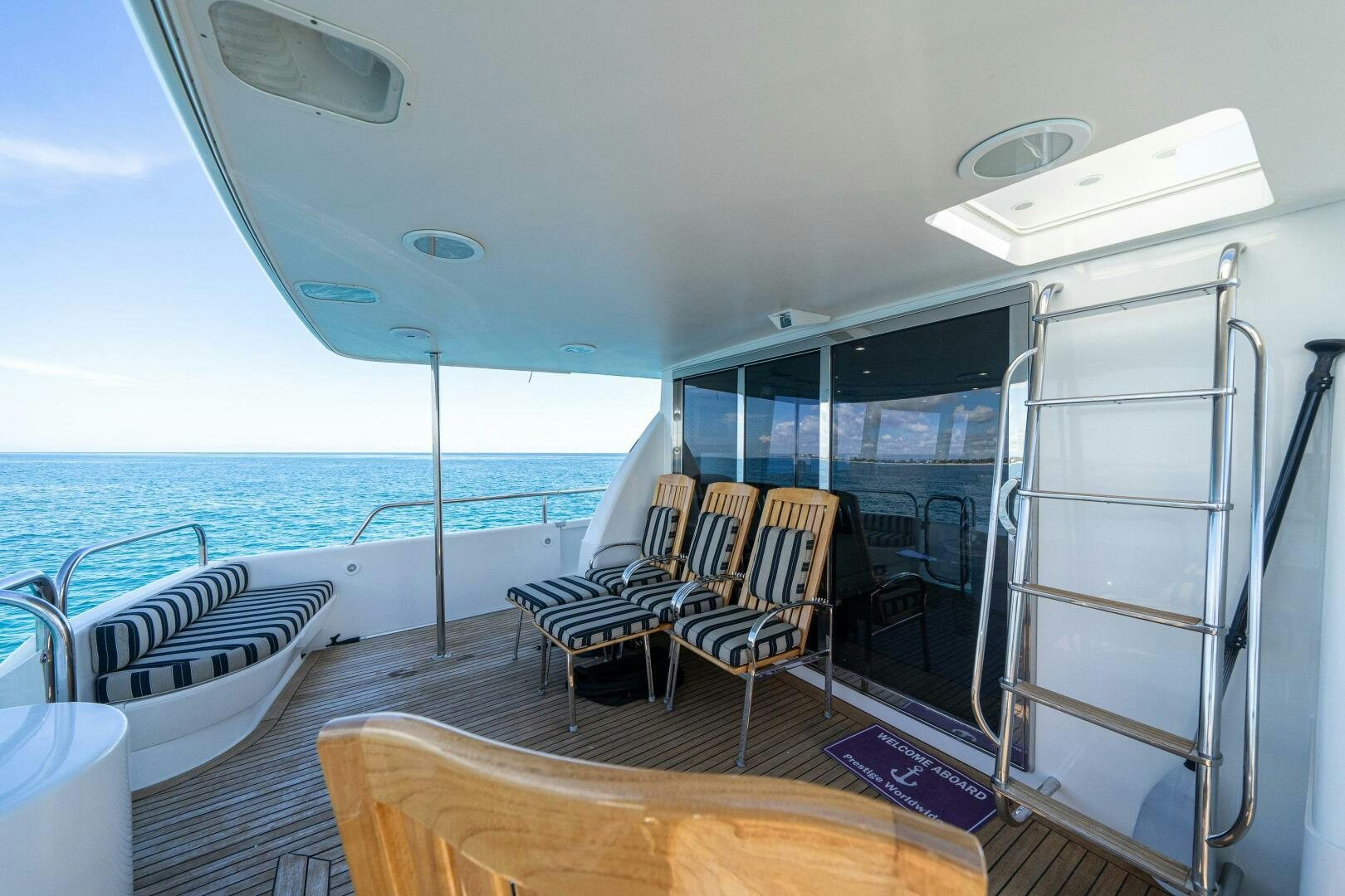 a boat with chairs and a table on the deck aboard PRESTIGE WORLDWIDE Yacht for Sale