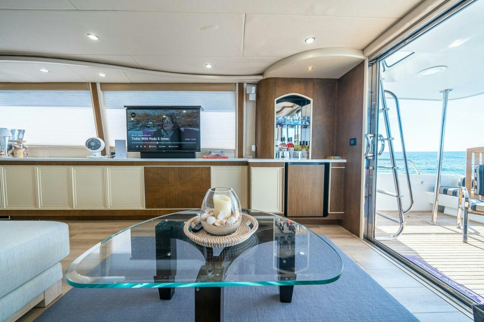 a living room with a glass table aboard PRESTIGE WORLDWIDE Yacht for Sale