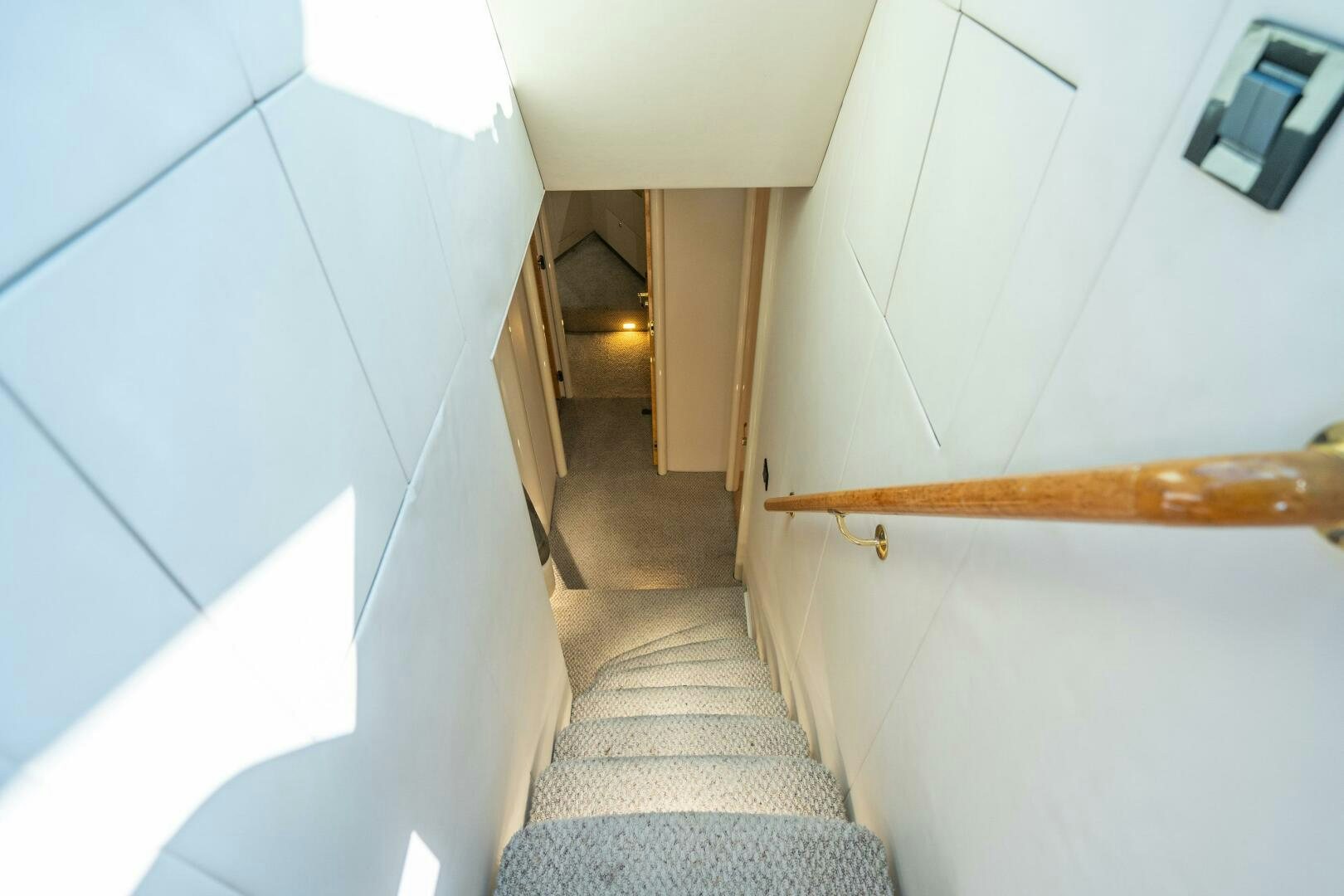 a staircase with a wood railing aboard PRESTIGE WORLDWIDE Yacht for Sale