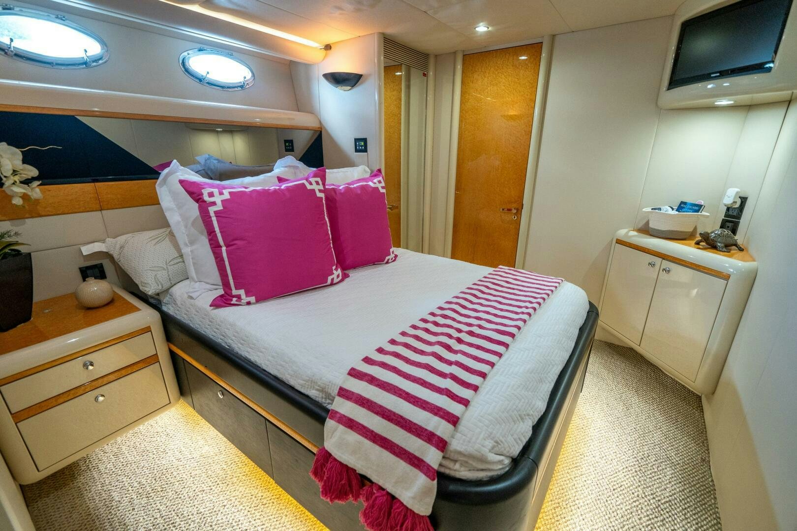 a bed with pink and white pillows aboard PRESTIGE WORLDWIDE Yacht for Sale
