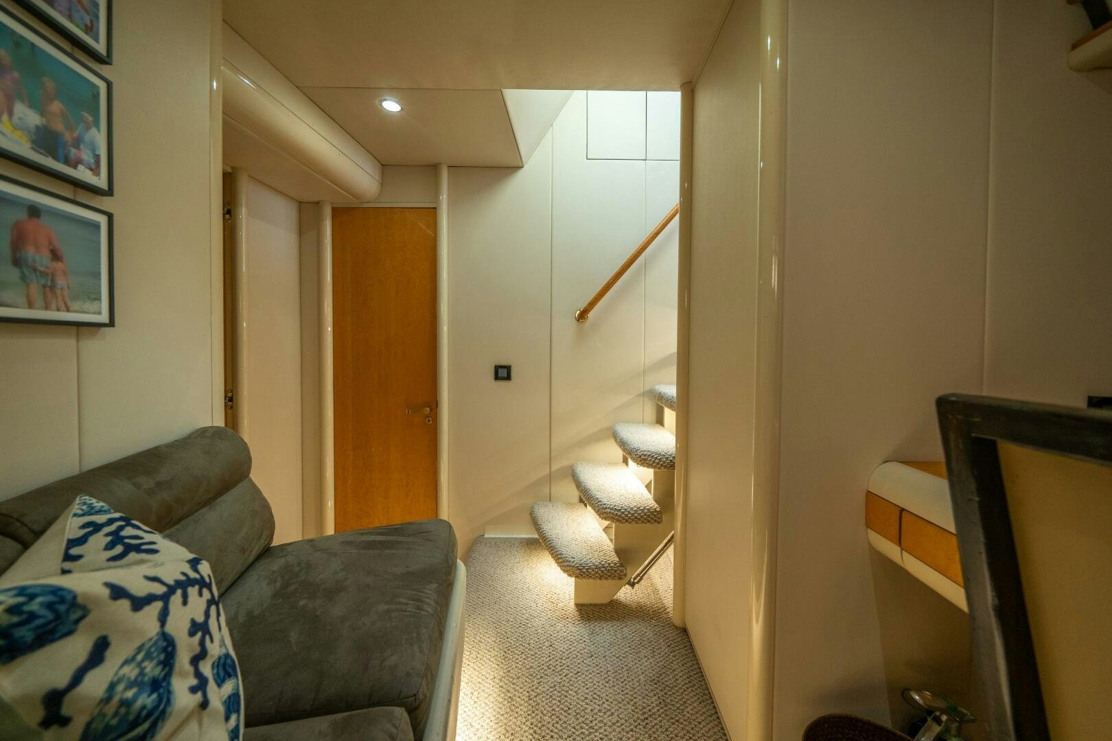 a living room with a couch and a staircase aboard PRESTIGE WORLDWIDE Yacht for Sale