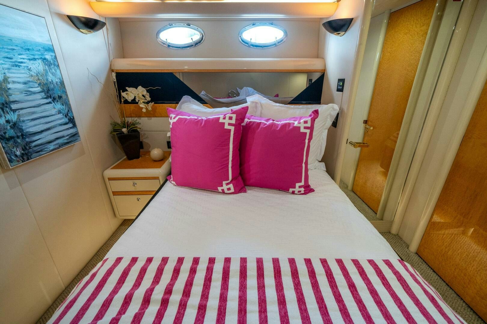 a bed with pink pillows aboard PRESTIGE WORLDWIDE Yacht for Sale